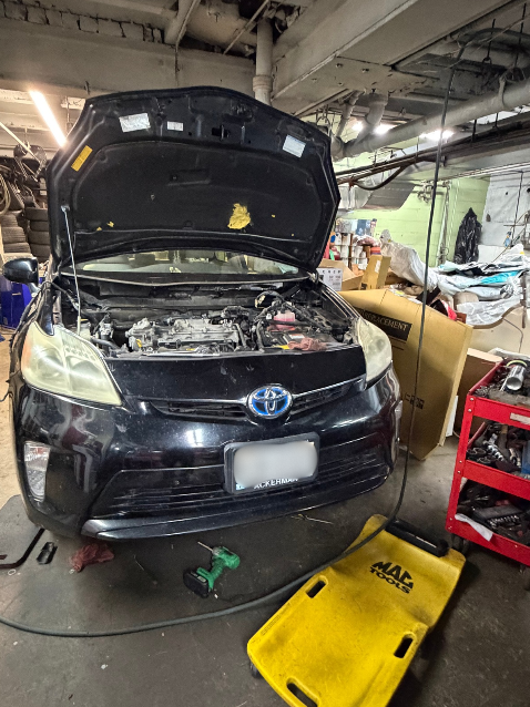 Toyota Prius with the hood open during a diagnostic inspection at C&R
